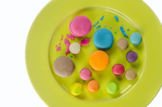 Colorful macaroons collection set on plate over white background