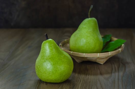 Fresh pears on the wooden background. Still life