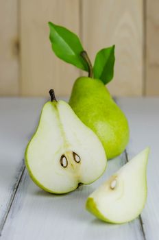One and a half green pears over white background