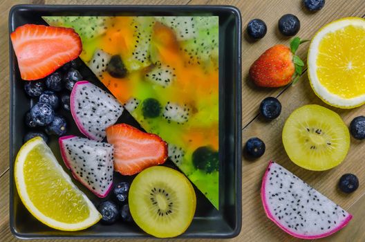 Top view of mixed jelly fruits ( strawberry, blueberry, kiwi, orange, dragon fruit )