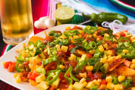 Close up of nachos salad over a colored poncho