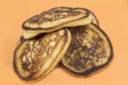 Closeup of lush fresh pancakes on a yellow background