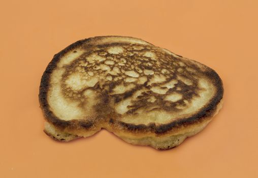 Delicious gingerbread pancake oil bath on a yellow background, close-up