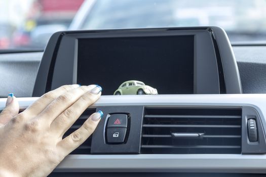 In the car with a fashionable girl hand manicure and small model cars