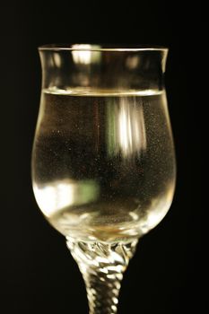 Sparkling water like champagne in a glass isolated on black