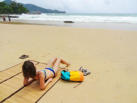 a beautifull woman in bikini lying on tropical beach in Thailand
