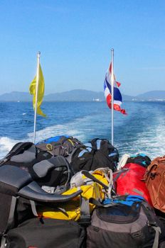 Stacked luggage and backpacks aboard of the heck a ferry during journey from phuket island to phi don, Thailand
