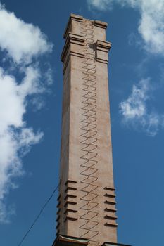 chimney with a ladder against a blue sky