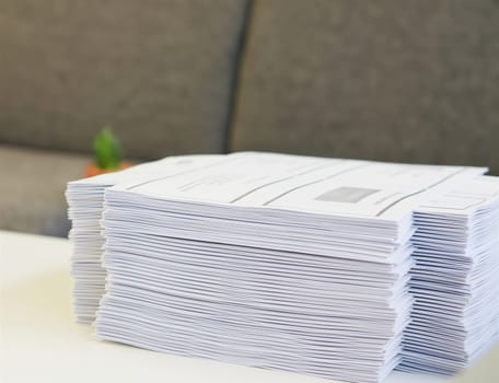 Stack of paper was put on table at office environment.