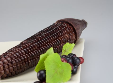 Purple sweet corn and some of grave put in plate.