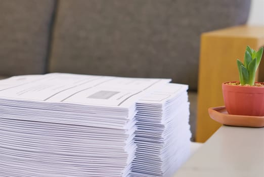 Stack of paper was put on table at office environment.