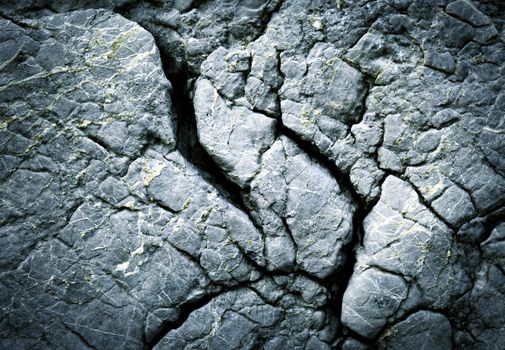abstract background dark fissured limestone rocks