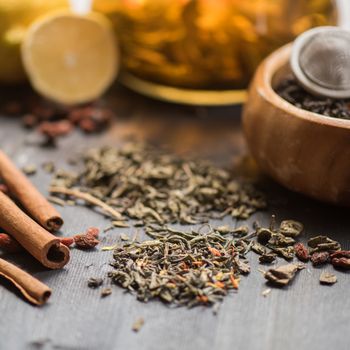 tea composition with cinnamon sticks, lemons and lime