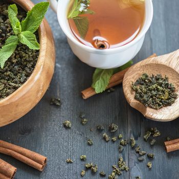 tea composition with cinnamon sticks, lemons and lime