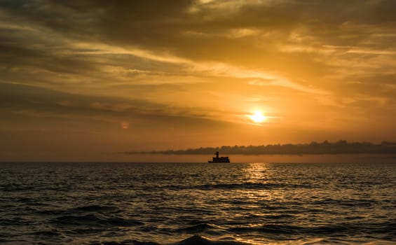 the sun rises over the sea in the beautiful clouds