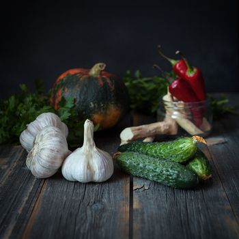 Vegetables on a surface from old boards with a dark background