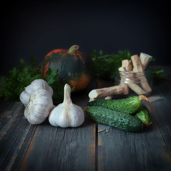 Vegetables on a surface from old boards with a dark background in style a rustic