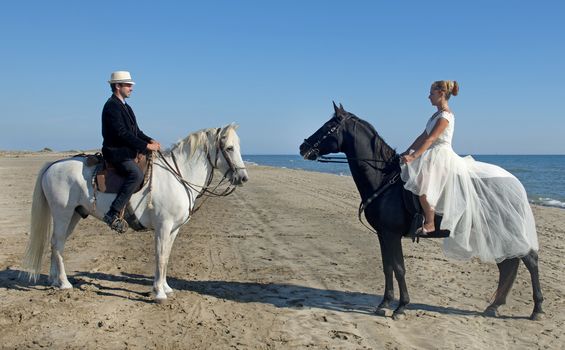 marrieds and horses on a beach in the south of France