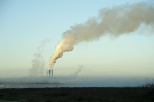 The Proserpine sugar mill, Queensland, Australia belching steam into the air from its chimneys