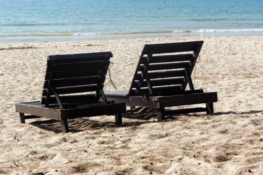wooden beach chairs on beautiful island in white sand plage