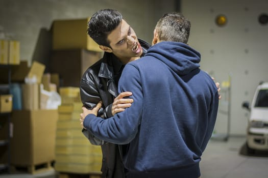 Close up Hungry Young Male Vampire with Scary Facial Expression Bites the Neck While Holding a Man