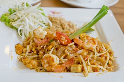 Delicious rice noodles with shrimp close-up on a plate. Thai Dish, in Thai Language we call Pad-Thai