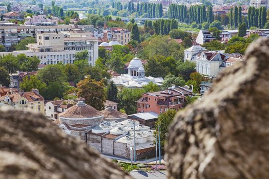 View of Plovdiv, Bulgaria downtown with old and new buildings and trees along Maritsa river.