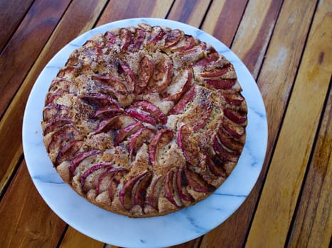 Sweet homemade apple cake pie served on a plate on a wooden table
