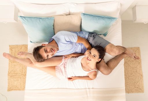 Young couple dating on a hotel bedroom