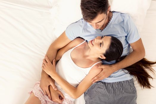 Young couple dating on a hotel bedroom