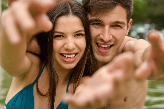 Portrait of a young couple embraced inside the pool