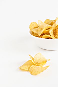 potato chips in a white dish isolated.