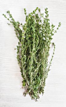 bunch fresh thyme on a wooden table background.