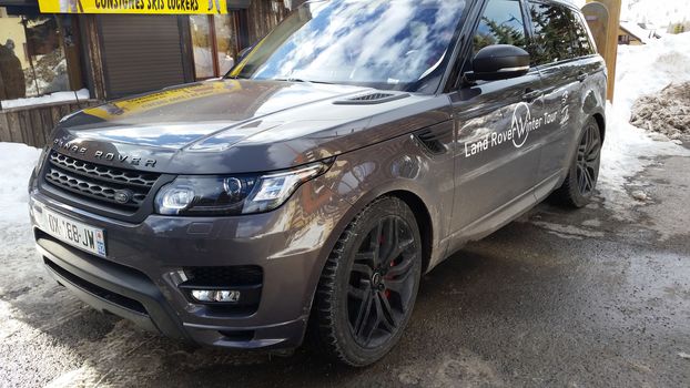 Isola 2000, France - February 19, 2016: Luxurious Land Rover Range Rover Sport SUV Parked on the Snow in a Ski Resort, Commune of Isola, Alpes-Maritimes