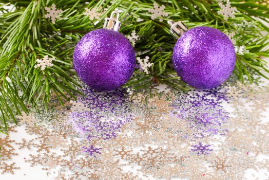 fir tree branch and Christmas toys bauble and snow flares confetti with copy space