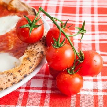 Detail of a Real Italian Pizza in Naples with Ciliegino tomatos