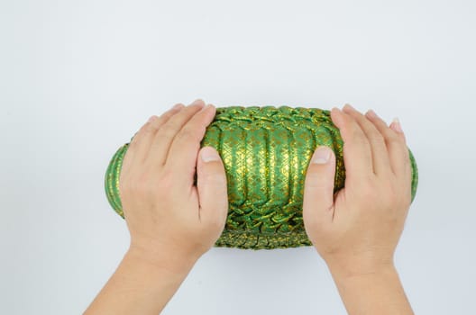 Thai silk Pumkin Pillow and hand on white background