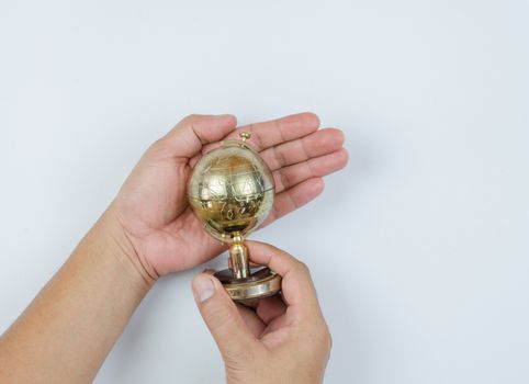 Golden Globe in hand isolated on white background