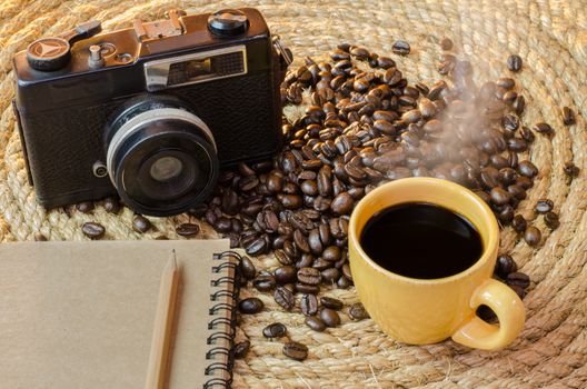 Cup of coffee with an old camera notebook on a jute rope.