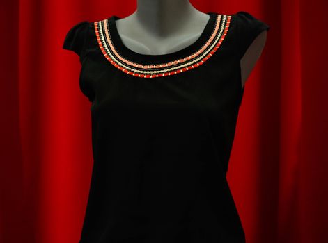 picture of a fashion summer clothes on a manequin doll on a red background
