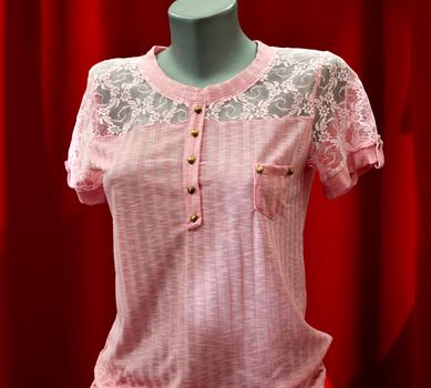 picture of a fashion summer clothes on a manequin doll on a red background