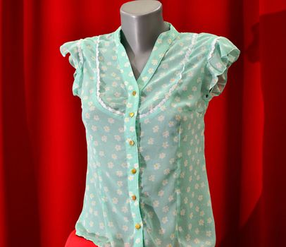 picture of a fashion summer clothes on a manequin doll on a red background