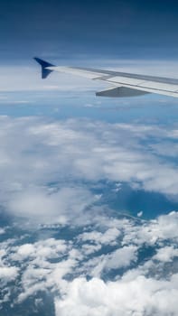 The airplane wing on the beautiful cloudy and sky.