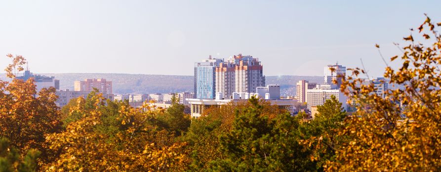 fall Cityscape, high-rise buildings and trees yellowed