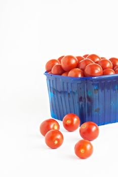 blue plastic box full of tomatoes isolated.