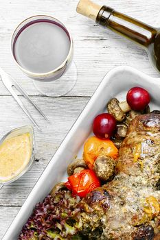 Meatloaf in the shape of a shank in the form for baking with vegetables