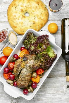 Meatloaf in the shape of a shank in the form for baking with vegetables