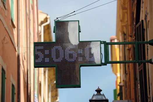 Neon Pharmacy Sign with the Time 5:06 in Italia