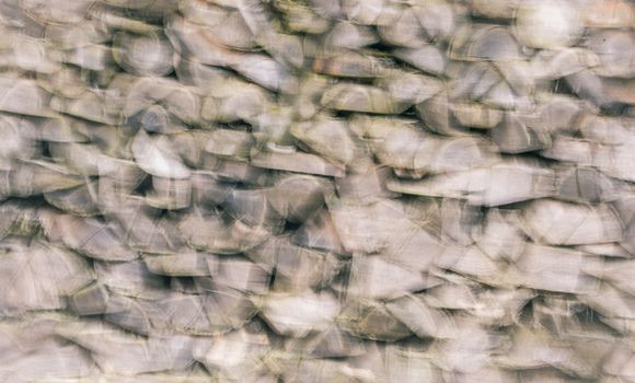 Blurry settings with a bunch of firewood chopped logs stacked in a pile, great abstract background.