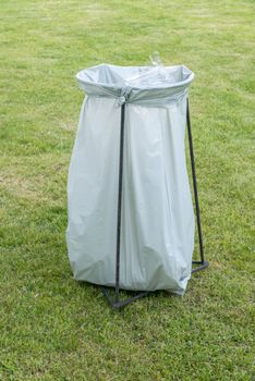 the trashcan - a plastic garbage bag on an iron frame